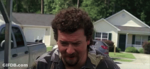 Man With Curly Hair And Beard Standing In Front Of House And Truck GIF