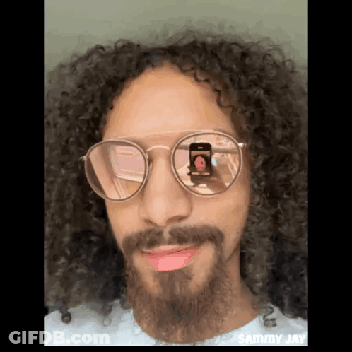 Man With Curly Hair And Beard Taking Photo GIF