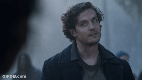Man With Curly Hair And Blue Eyes In Black Coat GIF