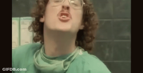 Man With Curly Hair And Glasses In Surgical Gown And Mask GIF