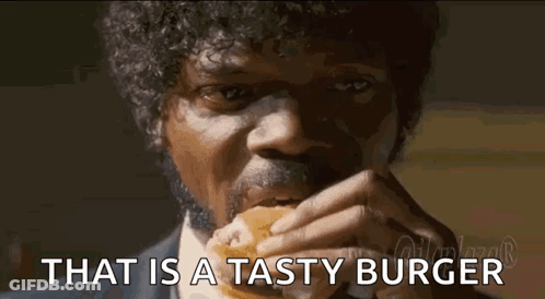 Man With Curly Hair And Mustache Eating Tasty Burger GIF