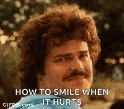 Man With Curly Hair And Mustache Smiling About How To Smile When It Hurts GIF
