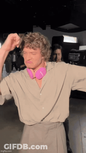 Man With Curly Hair And Pink Headphones GIF