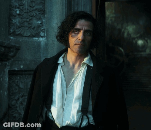 Man With Curly Hair And Suspenders In Front Of Building GIF
