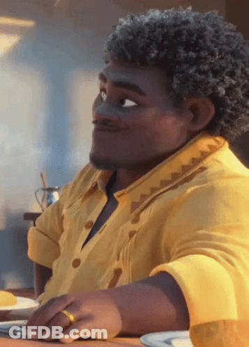 Man With Curly Hair And Yellow Shirt Sitting GIF