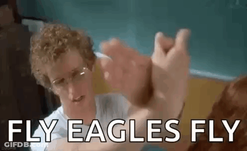 Man With Curly Hair High-Fiving Glasses Man GIF