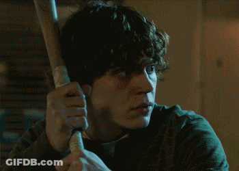Man With Curly Hair Holding Baseball Bat GIF