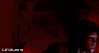 Man With Curly Hair Holding Flashlight GIF