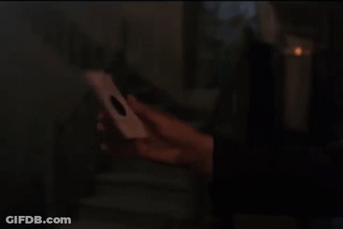 Man With Curly Hair Holding Paper GIF