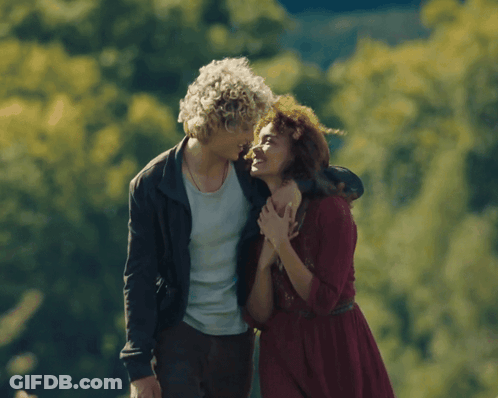 Man With Curly Hair Hugging Woman In Red Dress GIF
