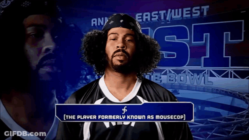 Man With Curly Hair In Front Of East West Bowl Sign GIF