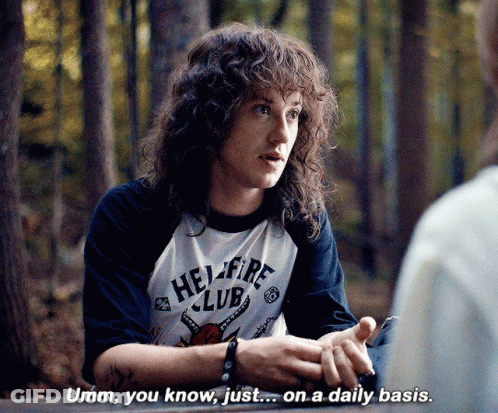 Man With Curly Hair In Hellfire Club Shirt GIF