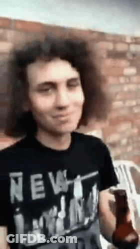 Man With Curly Hair In New York Shirt Holding Beer GIF