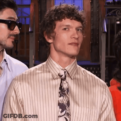 Man With Curly Hair In Striped Shirt And Tie GIF