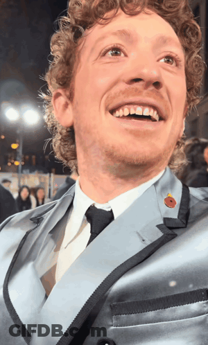 Man With Curly Hair In Suit And Tie GIF