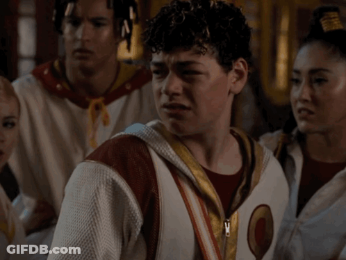 Man With Curly Hair In White Jacket With Letter O GIF