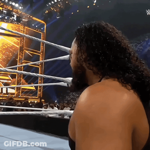 Man With Curly Hair In Wrestling Ring With W Logo GIF