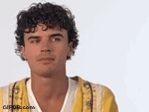 Man With Curly Hair In Yellow Jacket GIF