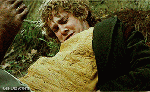 Man With Curly Hair Laying On Ground With Blanket On Chest GIF