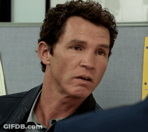 Man With Curly Hair Looking At Another Man GIF