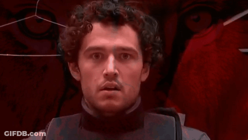 Man With Curly Hair Looking At Camera GIF