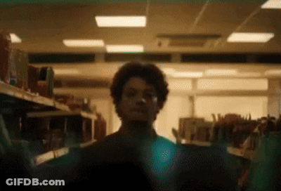 Man With Curly Hair Looking In Store GIF