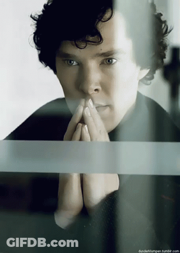 Man With Curly Hair Looking Out Window Hands Folded GIF