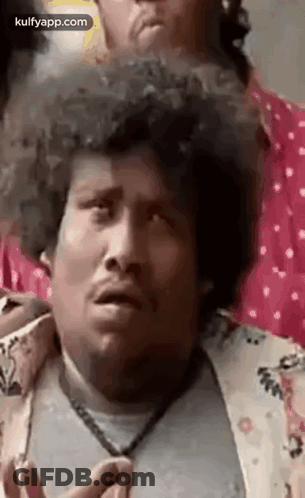 Man With Curly Hair Making Funny Face Next To Another Man GIF
