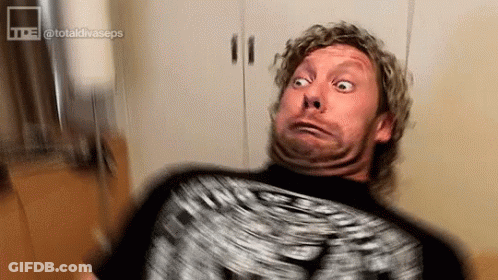 Man With Curly Hair Making Funny Face On Couch GIF