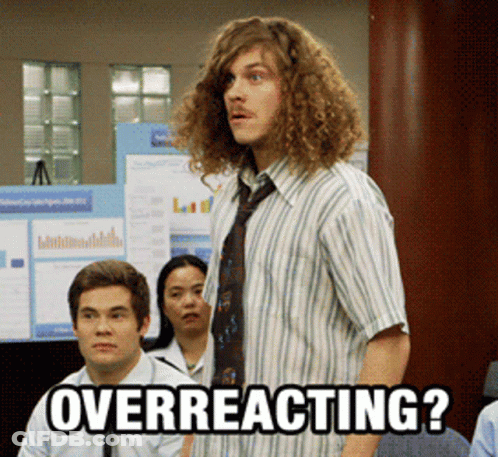 Man With Curly Hair Overreacting In Front Of Group GIF