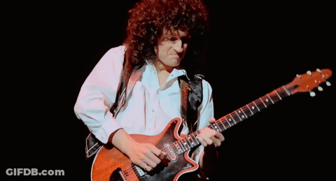 Man With Curly Hair Playing Guitar GIF