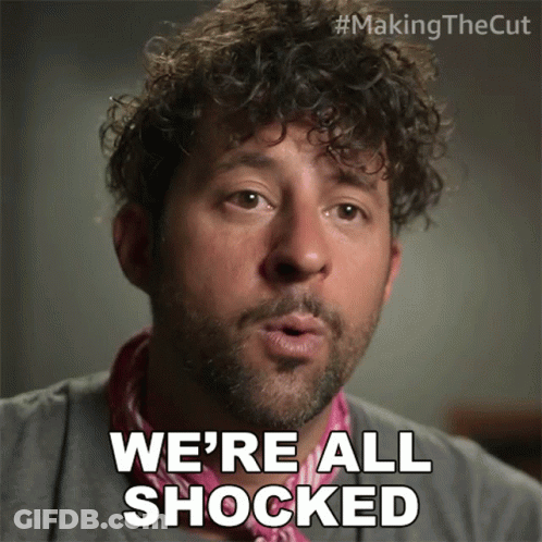 Man With Curly Hair Says We're All Shocked Wearing Pink Scarf GIF