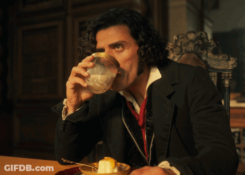 Man With Curly Hair Sitting At Table With Bowl Of Food GIF