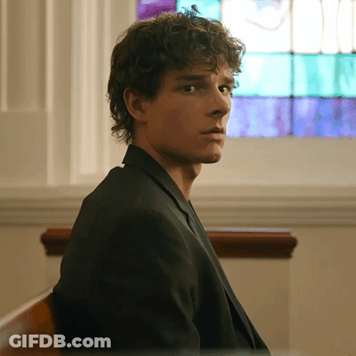 Man With Curly Hair Sitting In Front Of Window GIF