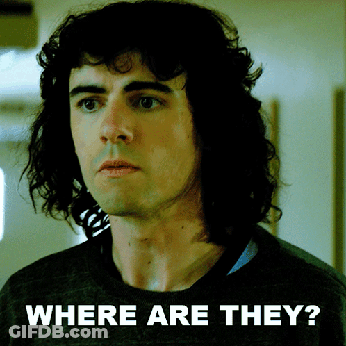 Man With Curly Hair Standing In Front Of Where Are They Sign GIF