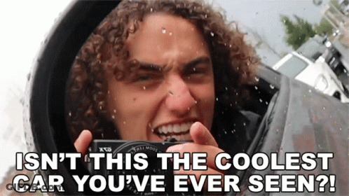 Man With Curly Hair Taking Photo Of Cool Car GIF
