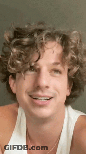 Man With Curly Hair White Tank Top And Necklace GIF