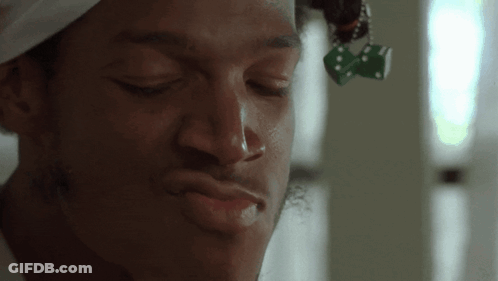 Man With Dice Hanging From Hair GIF
