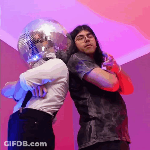 Man With Disco Ball Head Next To Microphone GIF
