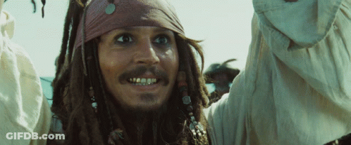 Man With Dreadlocks And Bandana Looking At Camera GIF