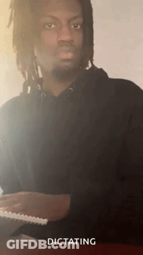 Man With Dreadlocks And Beard Dictating Paper GIF