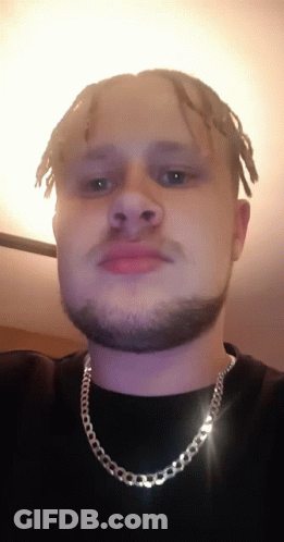 Man With Dreadlocks And Beard Wearing Silver Chain GIF