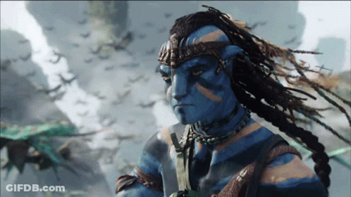 Man With Dreadlocks And Blue Face Standing Before Birds GIF