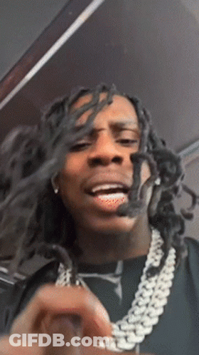 Man With Dreadlocks And Chain Making Face GIF