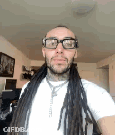 Man With Dreadlocks And Glasses In White Shirt GIF