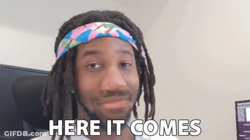 Man With Dreadlocks And Headband Saying Here It Comes GIF