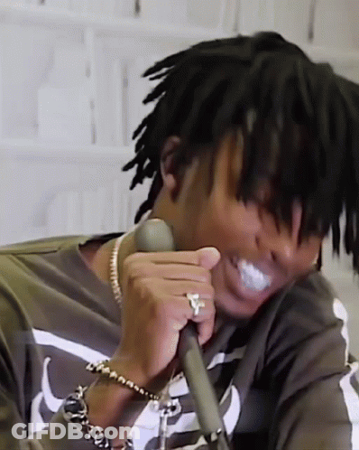 Man With Dreadlocks And Ring Holding Microphone GIF