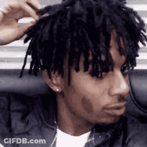 Man With Dreadlocks Brushing Hair GIF
