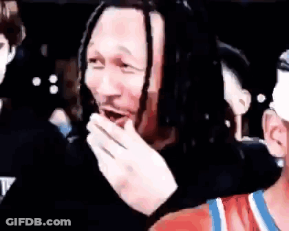 Man With Dreadlocks Covering Mouth GIF