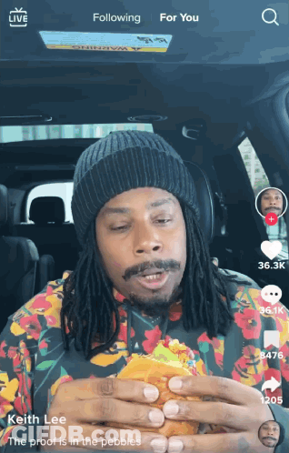 Man With Dreadlocks Eating Hamburger GIF